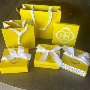 Kendra Scott two paper bags and four jewelry boxes.